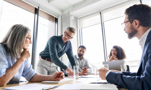 Male,Mature,Caucasian,Ceo,Businessman,Leader,With,Diverse,Coworkers,Team,